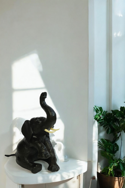 Handmade eco-friendly leather elephant statue with raised trunk and rustic finish